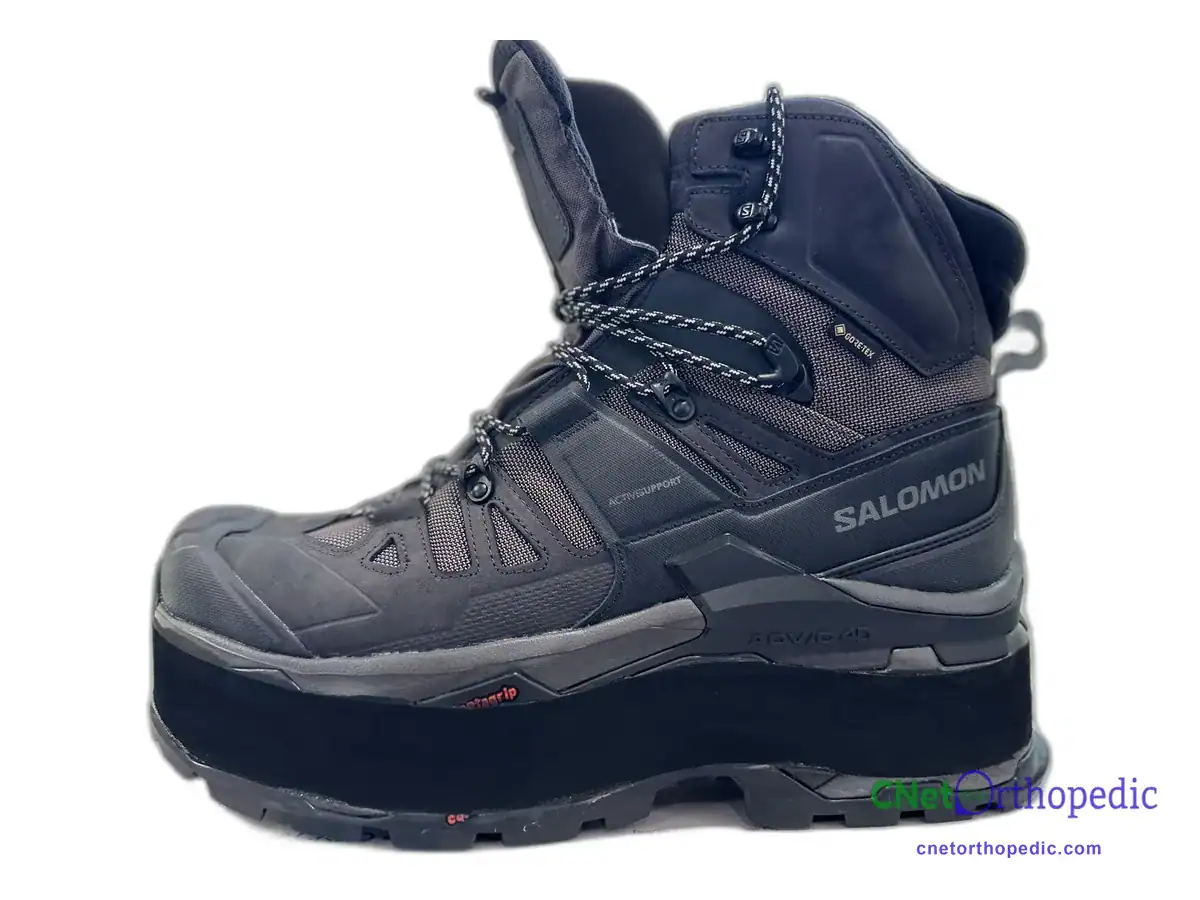 Grey Salomon hiking boot with a 3/4 inch shoe lift