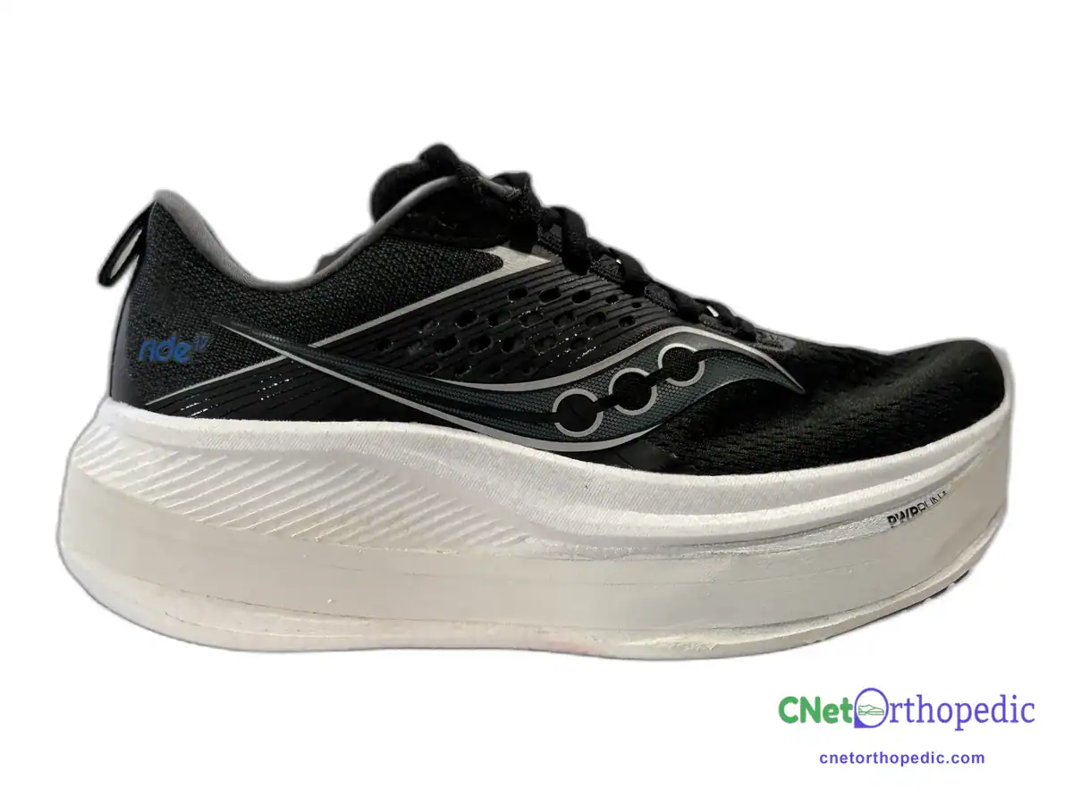 Black Saucony running shoe with a 1.5 inch white sole lift