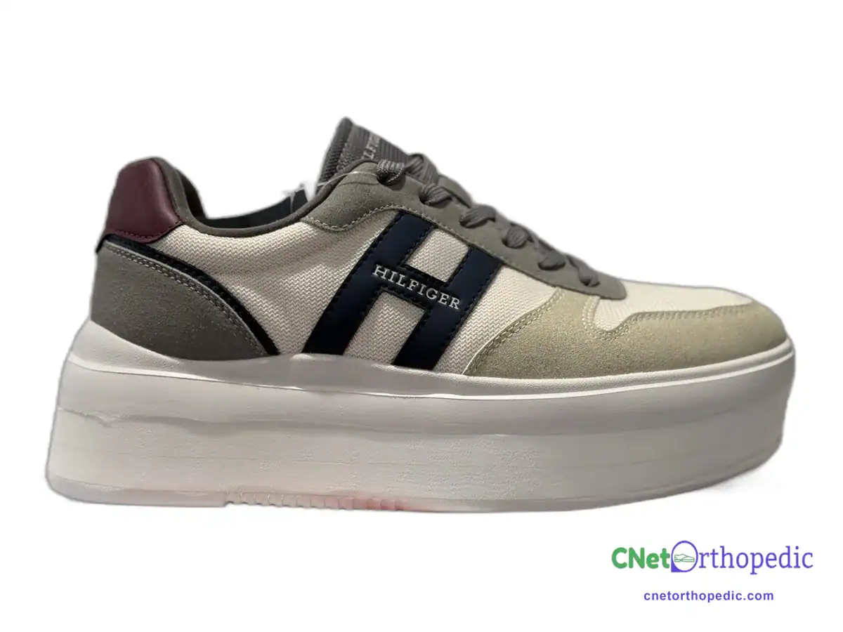 Grey Tommy Hilfiger sneaker with a 1.5 inch shoe lift built into the white sole