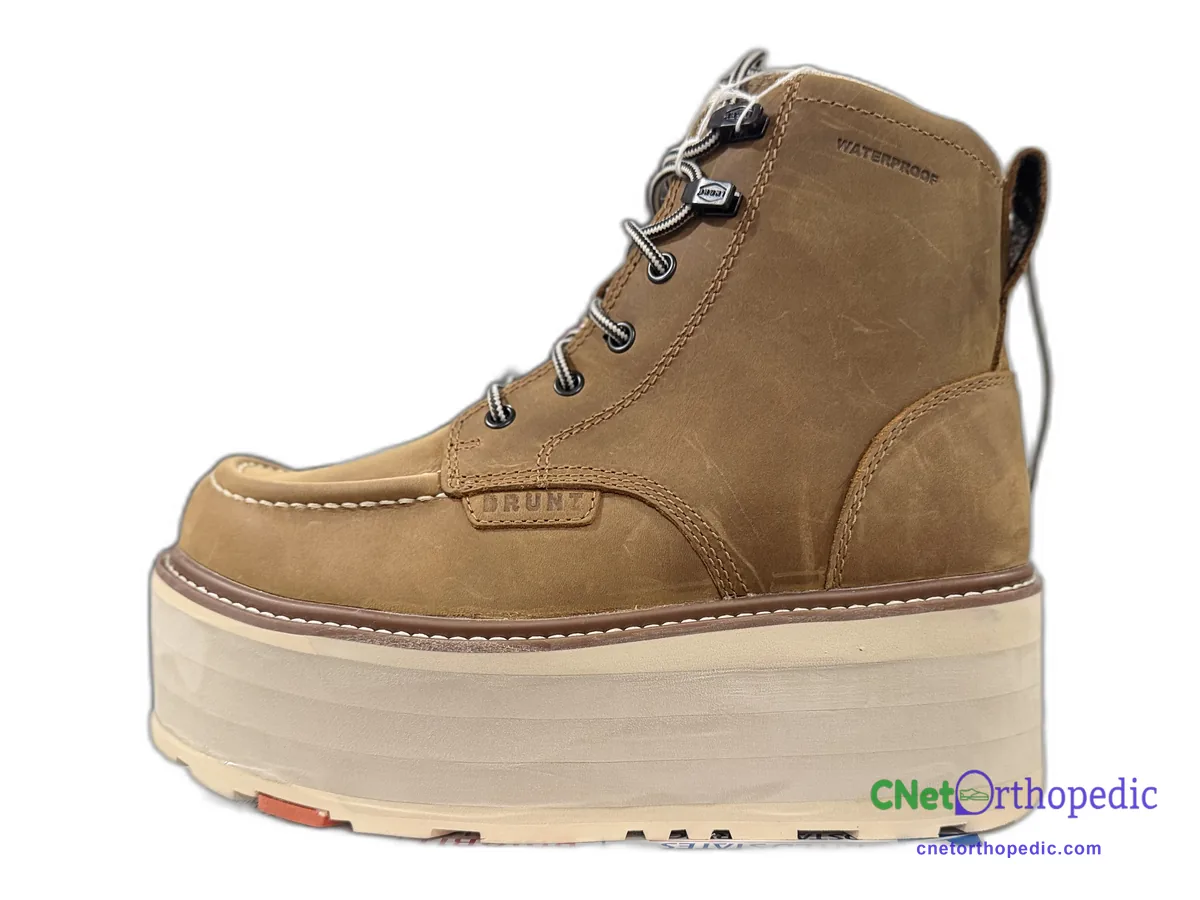 Tan leather boot with a 2 inch cream sole lift