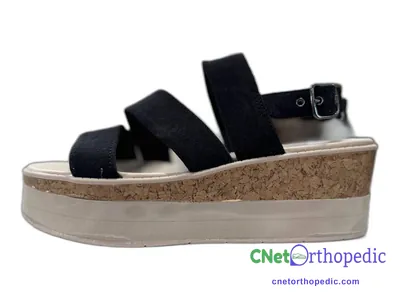 Shoe lift added to a women's black sandal