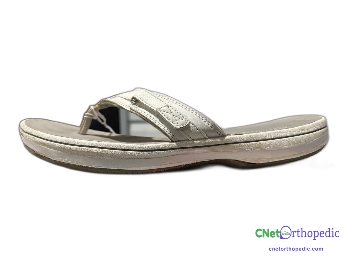 White flip-flop sandal with a thin 1/4 inch sole lift