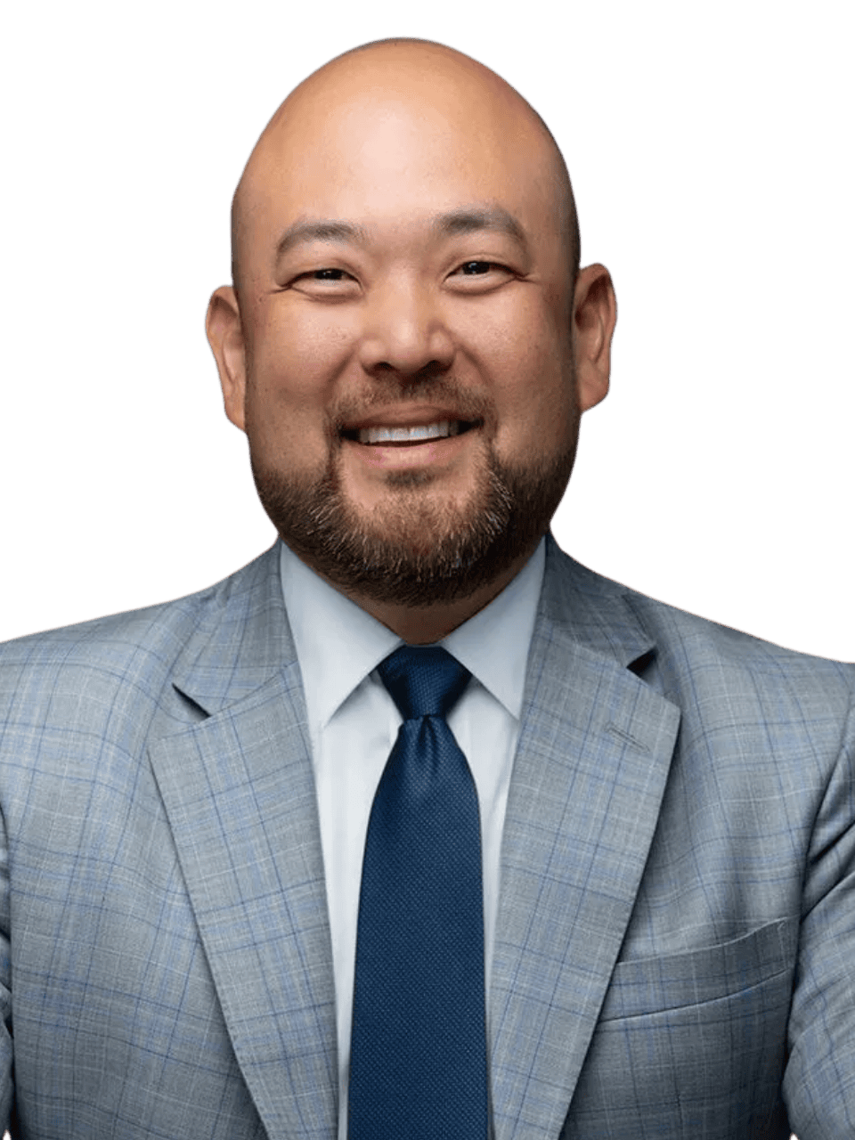 Professional man in a gray suit smiling for a corporate photo.