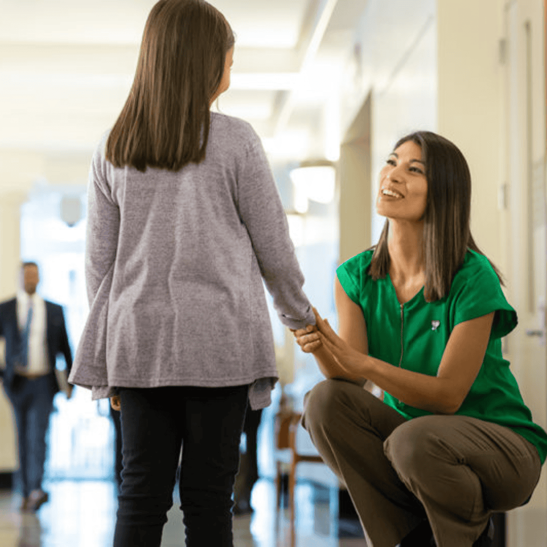 Smiling woman holding a girl