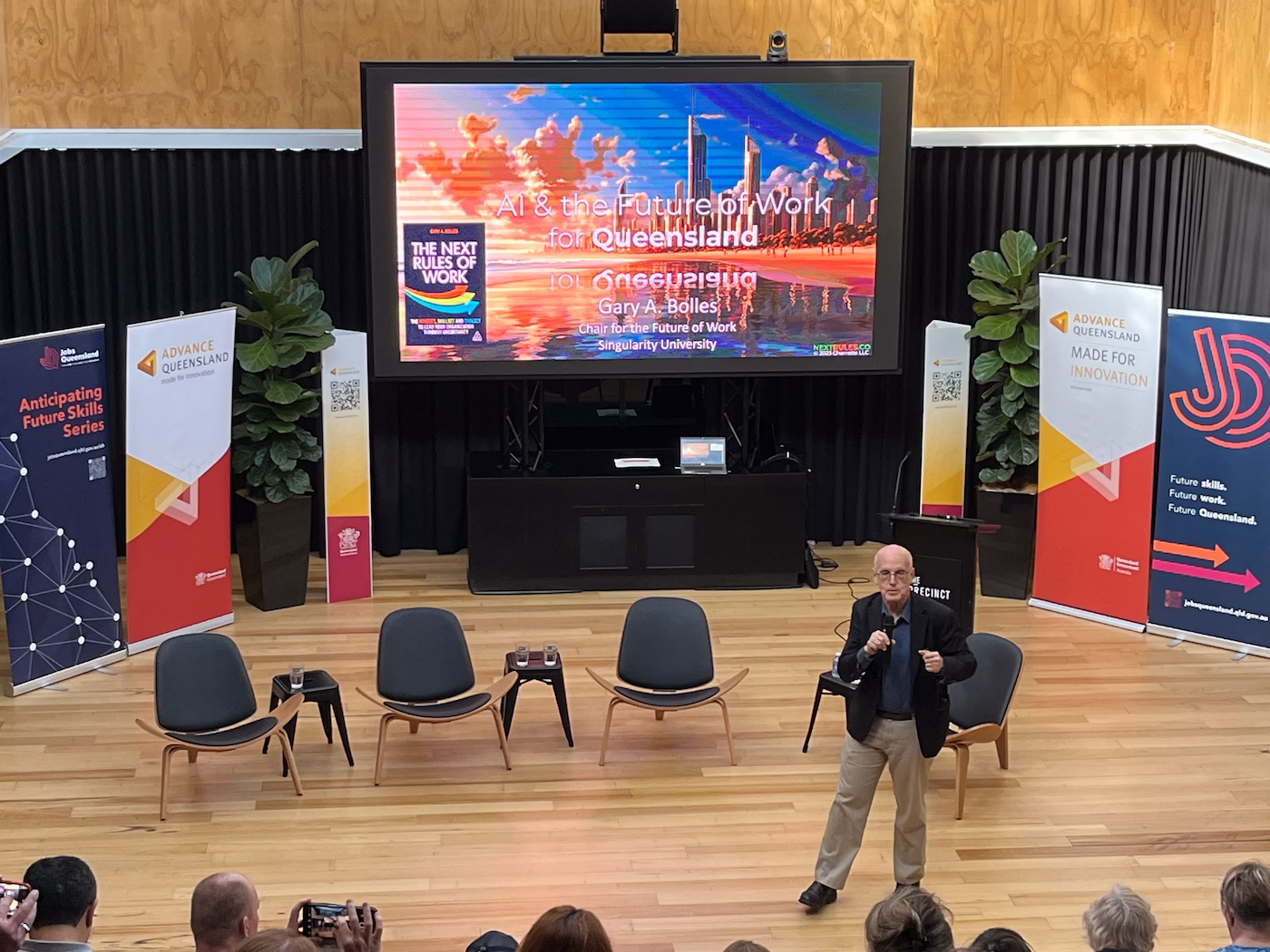 Gary Bolles presenting on artificial intelligence and the future of work for Queensland at The Precinct stadium stage, supported by Advance Queensland and Jobs Queensland.