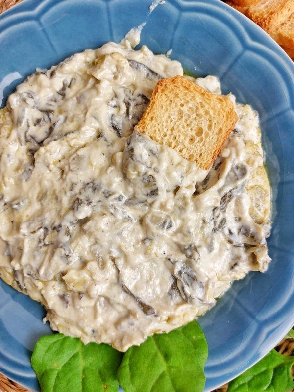 Creamy keto spinach and artichoke dip served in a bowl.