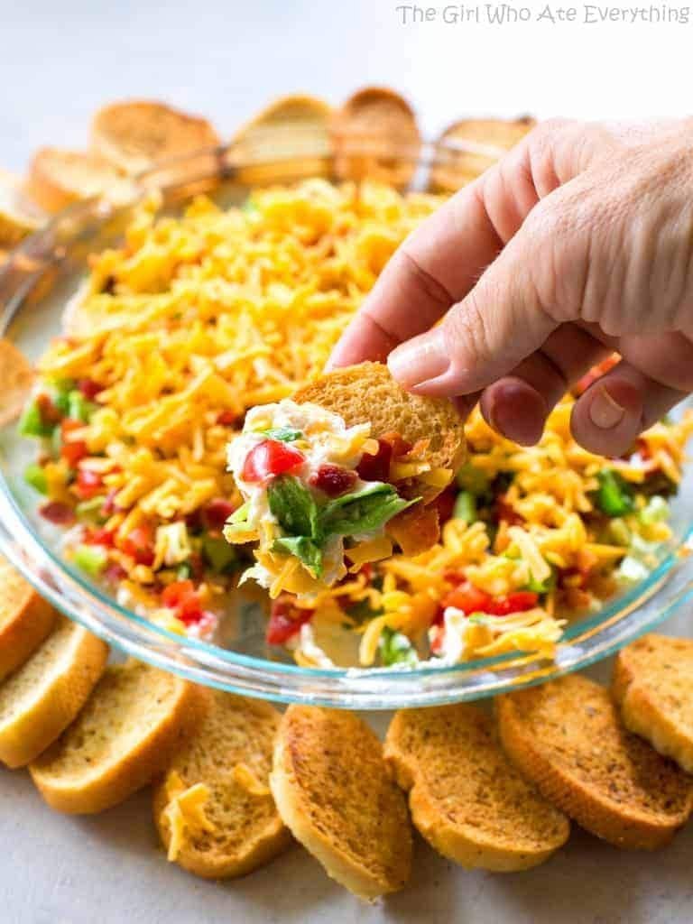 BLT dip topped with bacon, lettuce, and tomato.