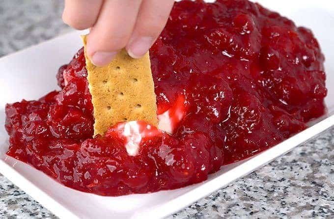 Cranberry cream cheese dip served with crackers.