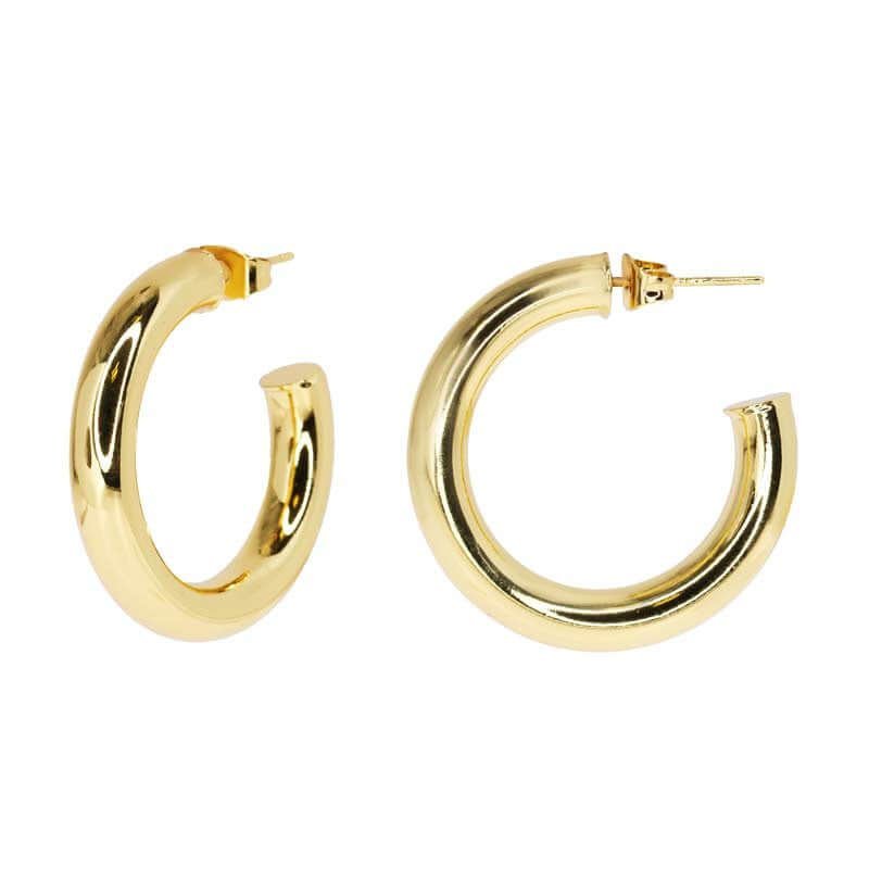 Chunky gold hoop earrings on white background