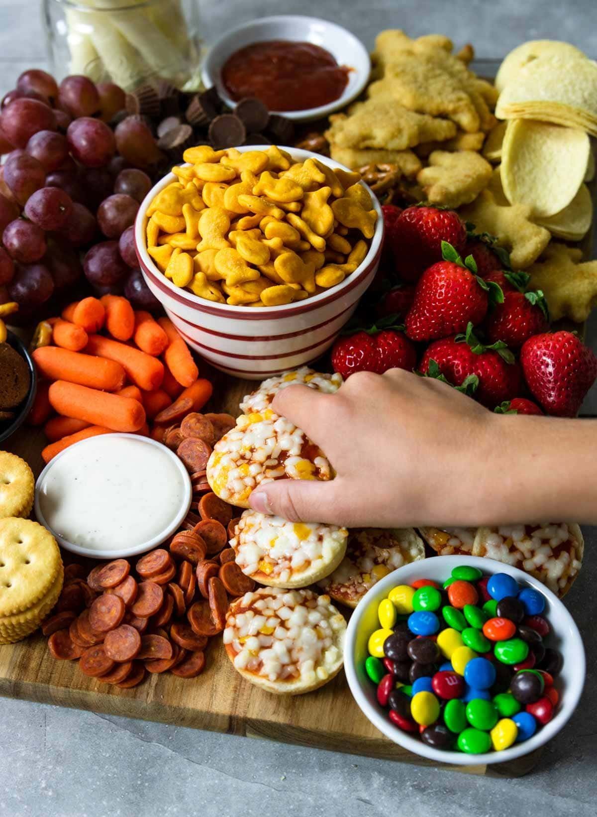 Kids charcuterie with colorful snacks and dips