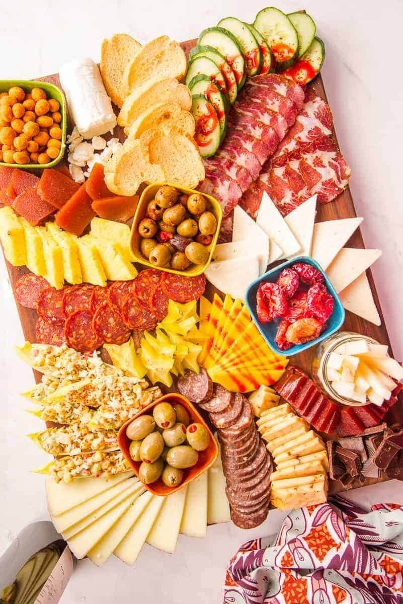 Mexican style board with cheeses, chorizo, guacamole and chips