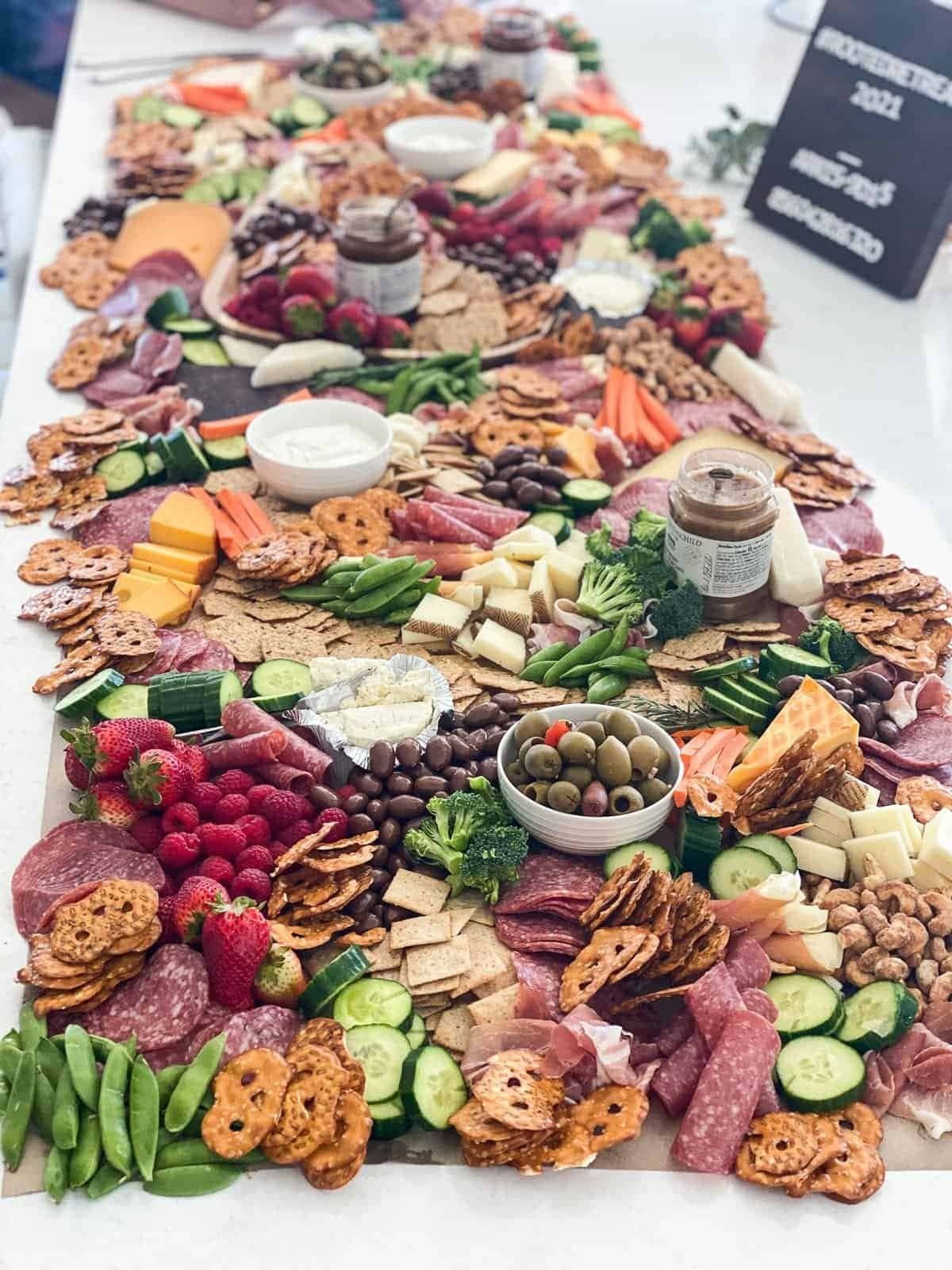 Large grazing table with cheeses, meats, fruit and breads
