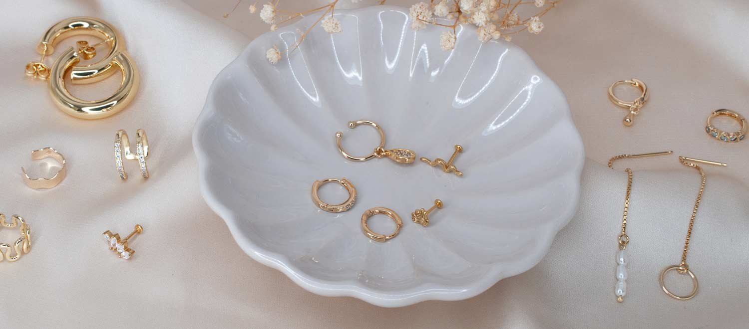 Close-up of minimalist gold earrings styled for sensitive ears