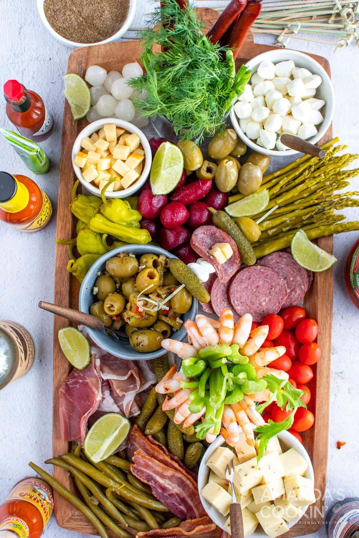 Bloody Mary board with garnishes and snacks