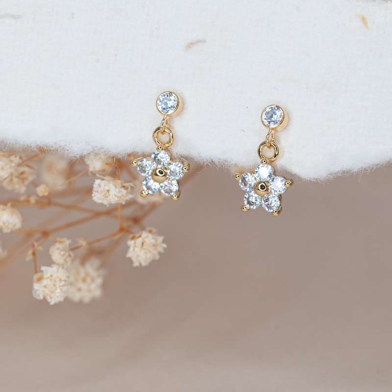 Delicate flower charm stud earrings — dainty everyday studs for a soft wellness look