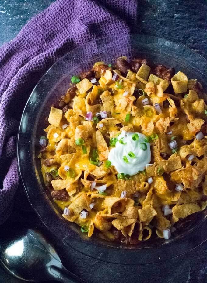 Frito pie topped with chili and cheese