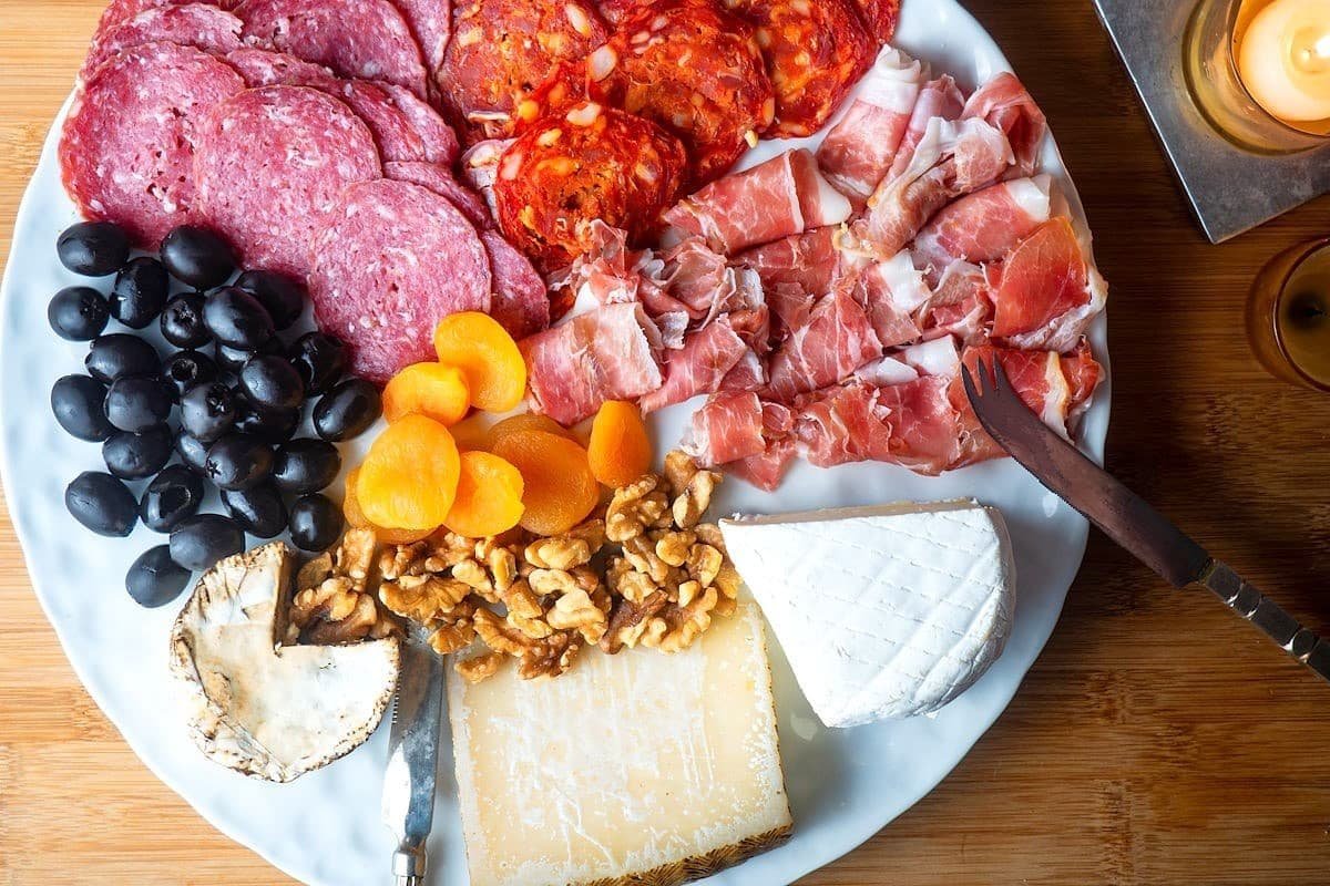Classic charcuterie board with meats, cheeses, crackers and fruit