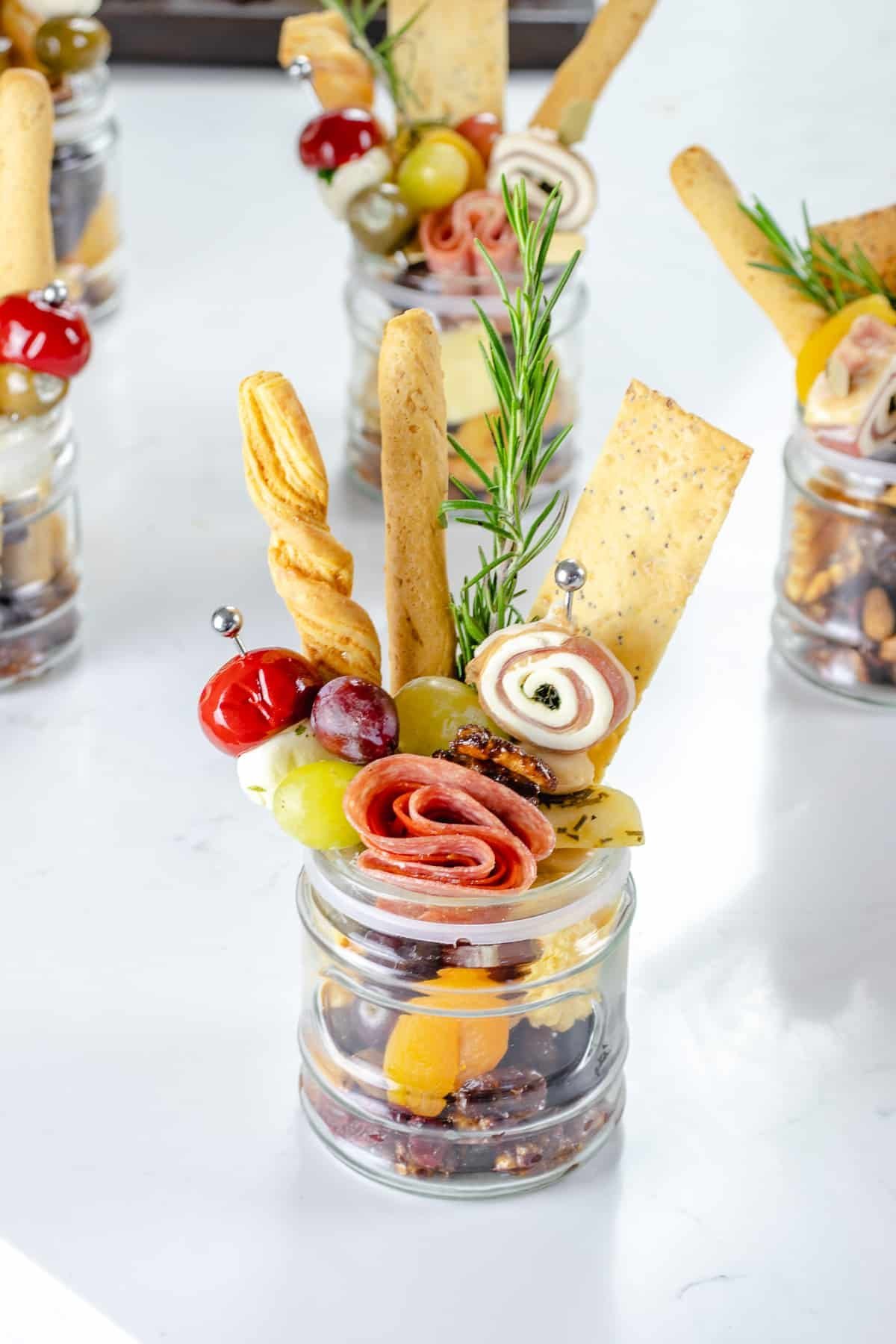 Individual charcuterie cups with meat, cheese and fruit