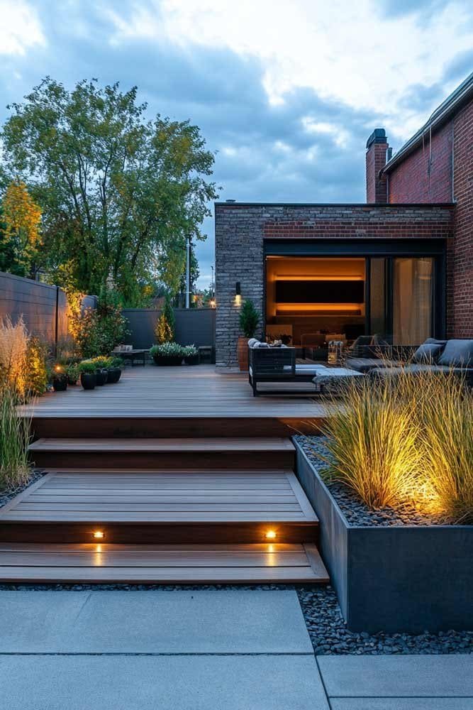 Modern minimalist backyard with wooden deck and potted grasses