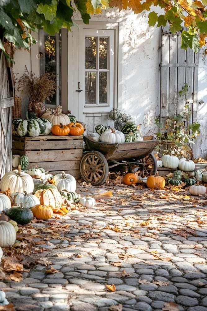 Rustic farmhouse porch decorated with pumpkins and lanterns