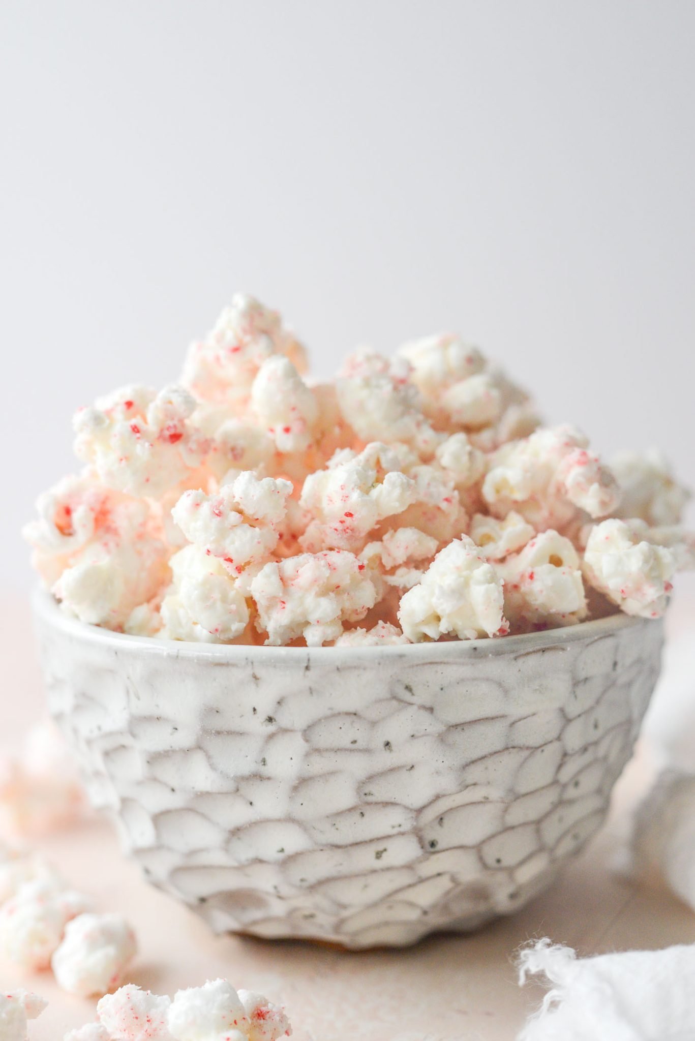 White chocolate peppermint popcorn sprinkled with crushed candy canes