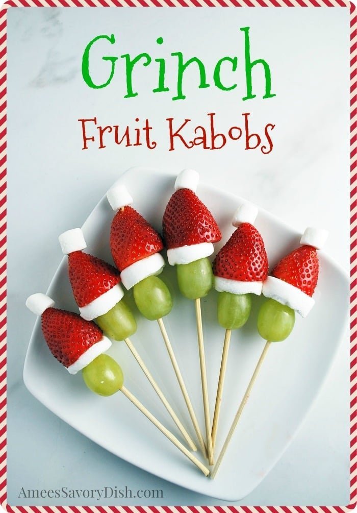 Grinch fruit kabobs made with grapes, strawberries, bananas and marshmallows
