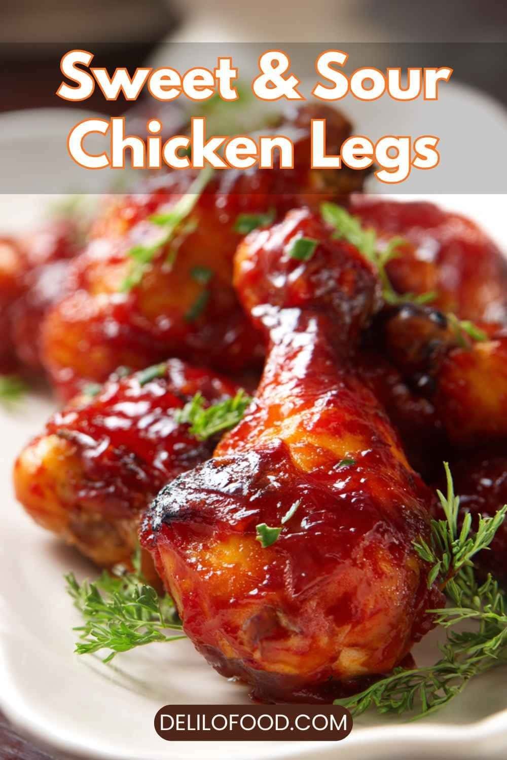 Sweet and sour chicken legs glazed with glossy red sauce, juicy baked drumsticks with herbs and warm colors.