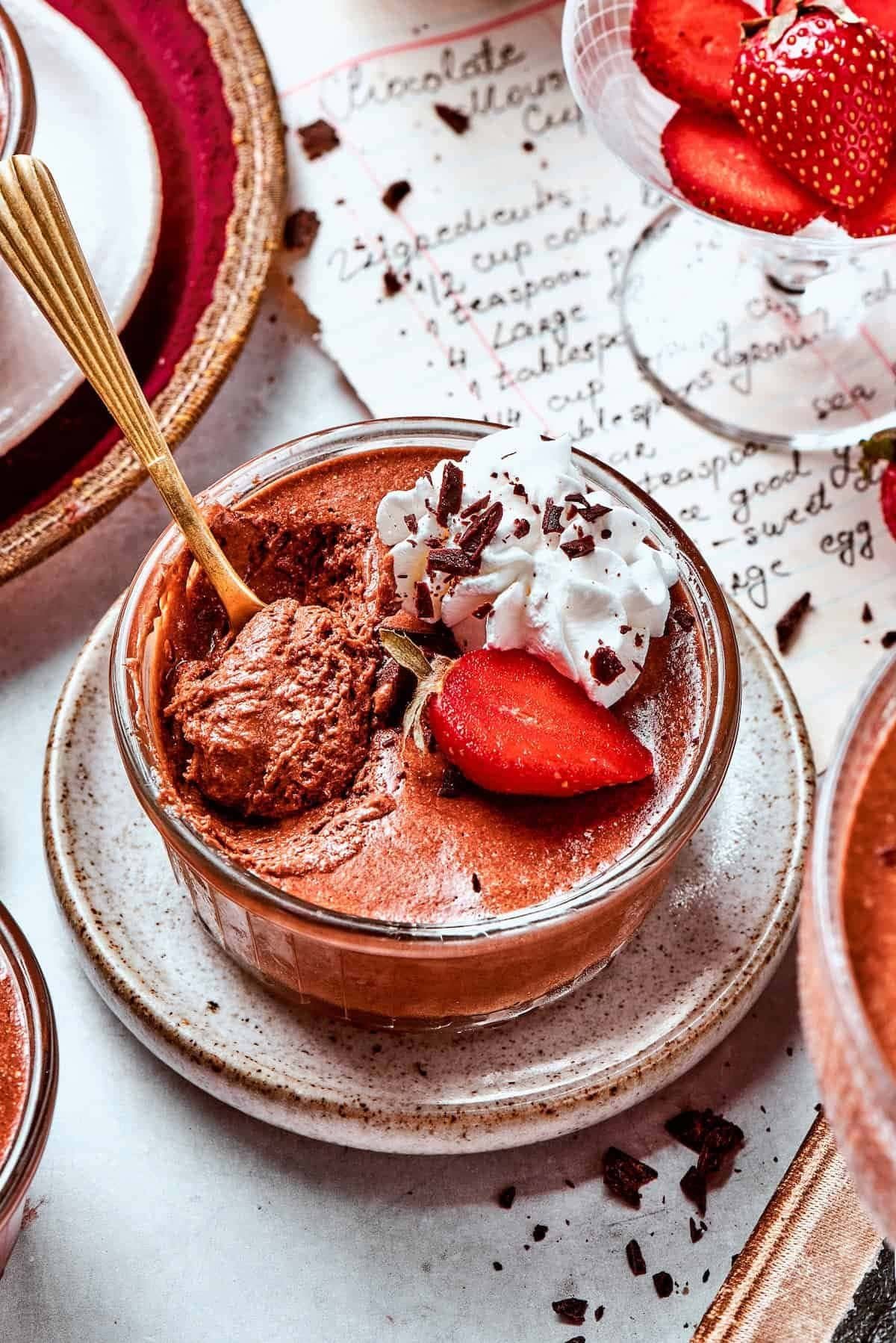 Chocolate mousse cups topped with strawberries and whipped cream