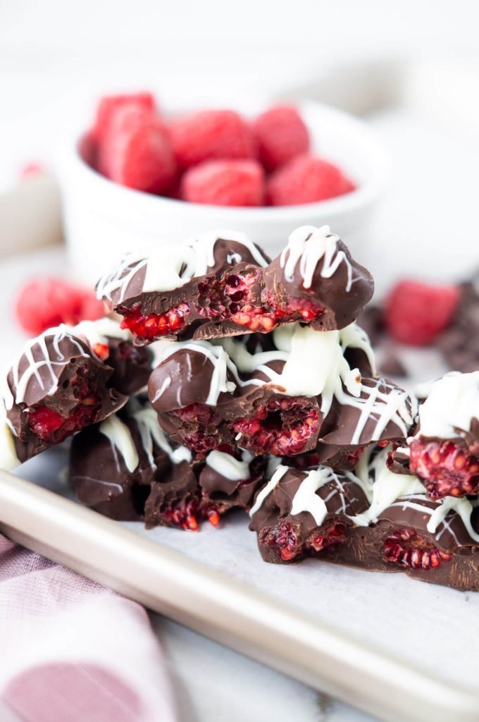 Raspberry chocolate bark pieces with white chocolate drizzle