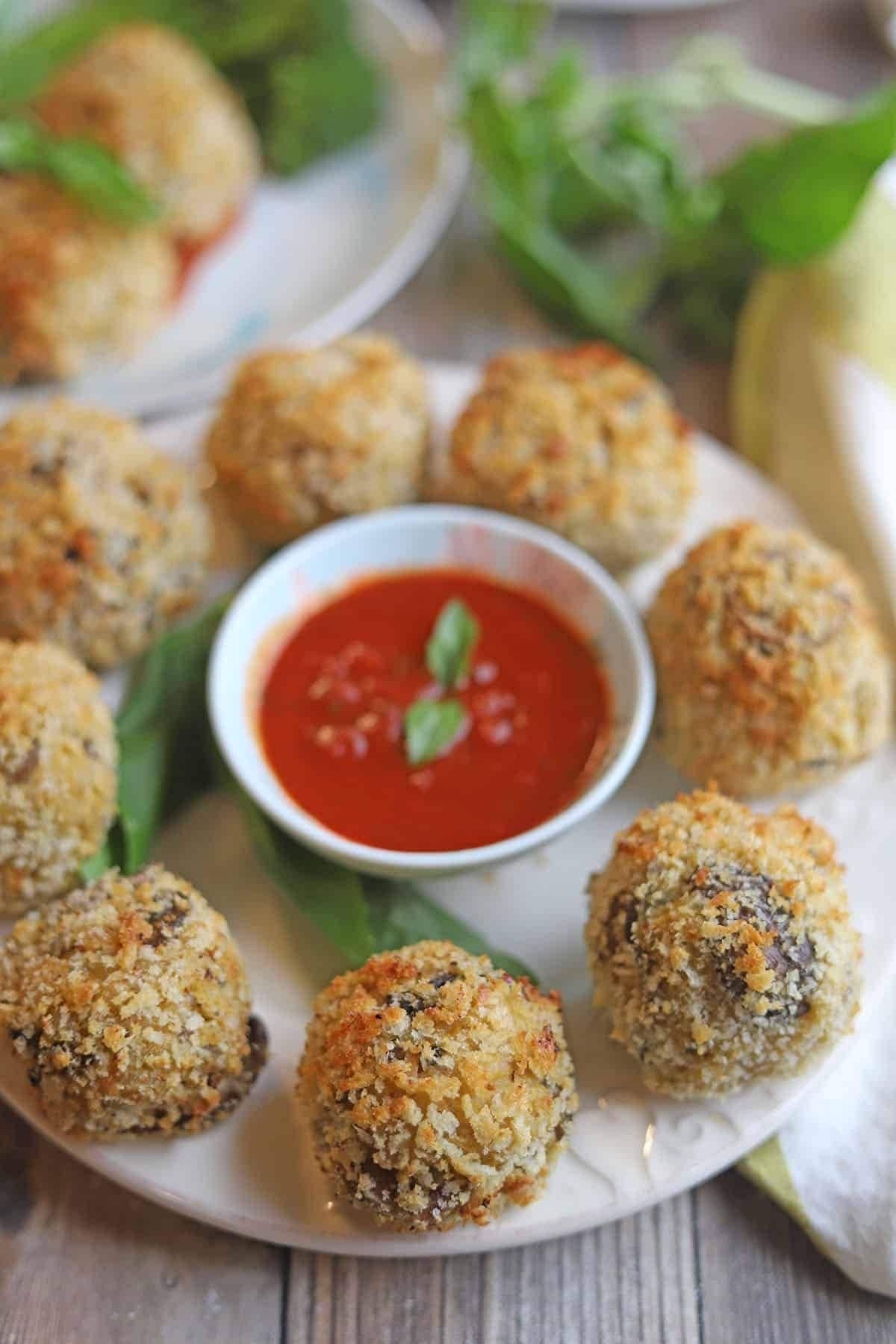 Crispy vegan arancini served with marinara sauce.