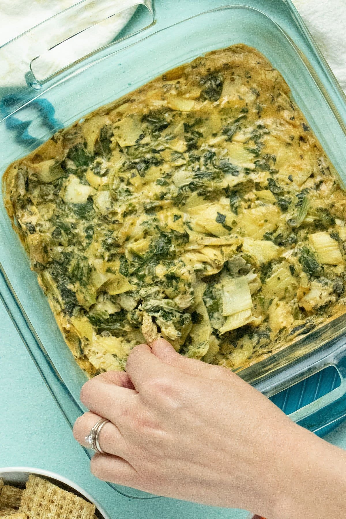 Creamy vegan spinach artichoke dip served in a bowl.