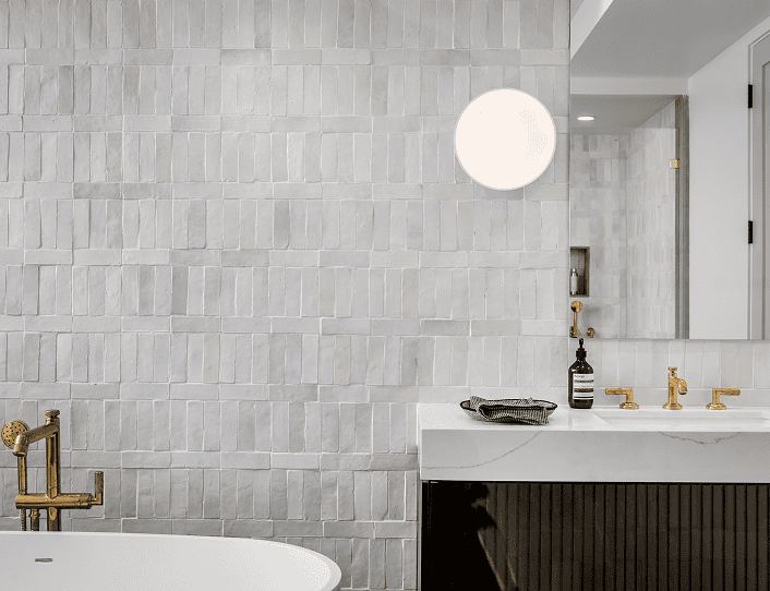 A bathroom with a white tub and a black sink.