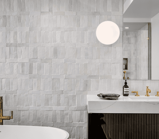 A bathroom with a white tub and a black sink.
