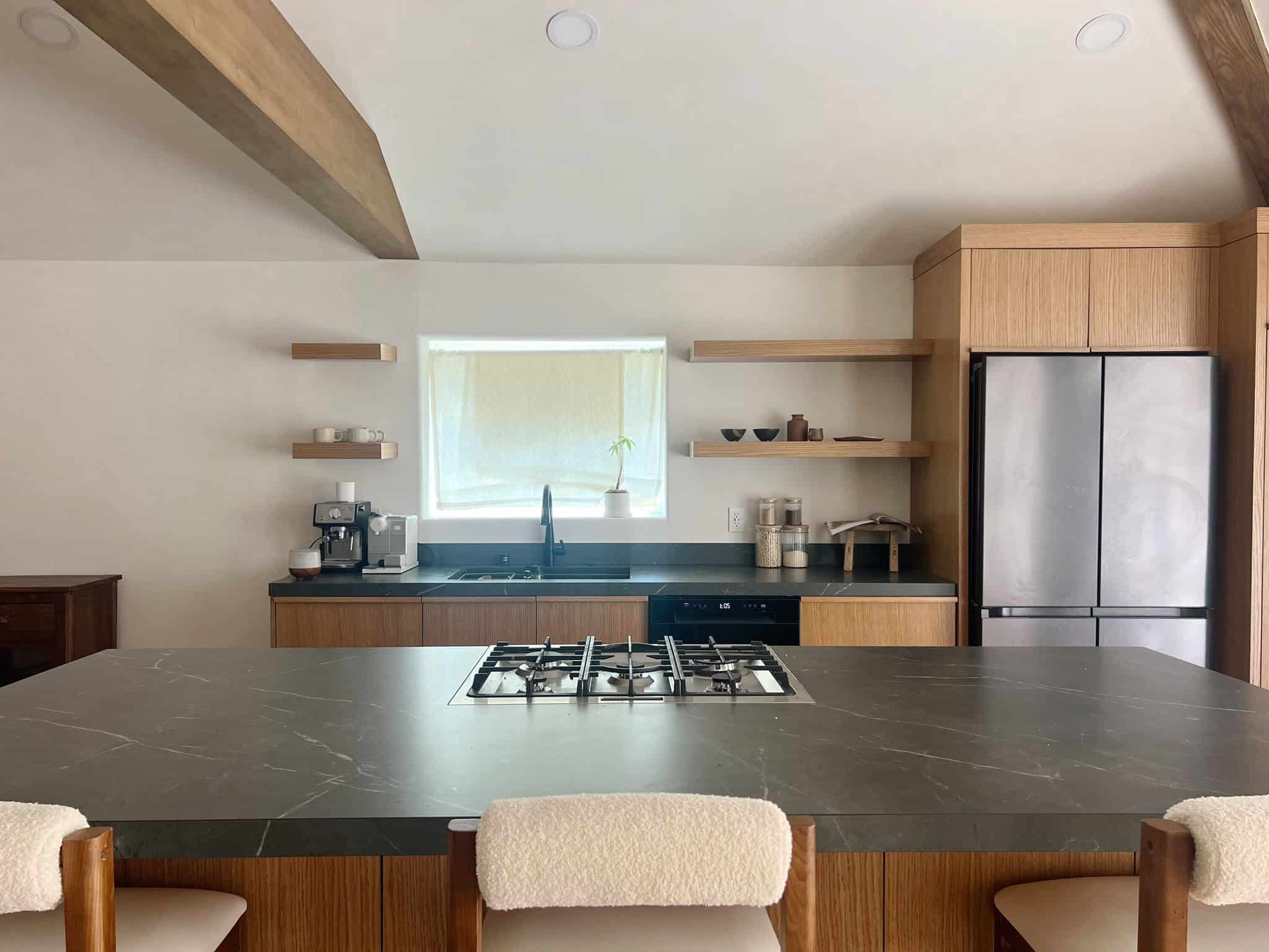 A kitchen with a large island and wooden cabinets.