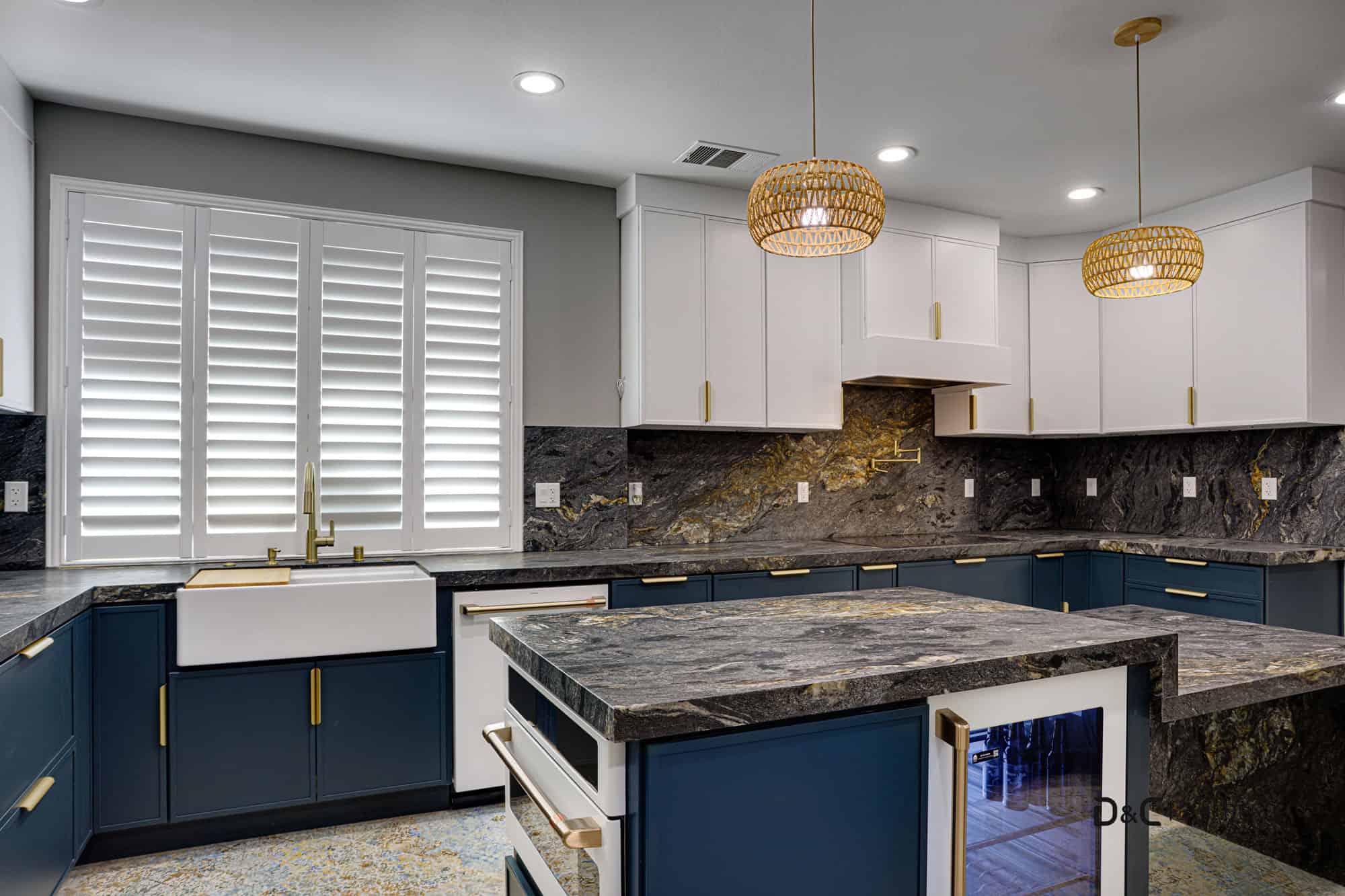 Modern kitchen remodel in Newport Beach featuring navy blue cabinets & floating white cabinets