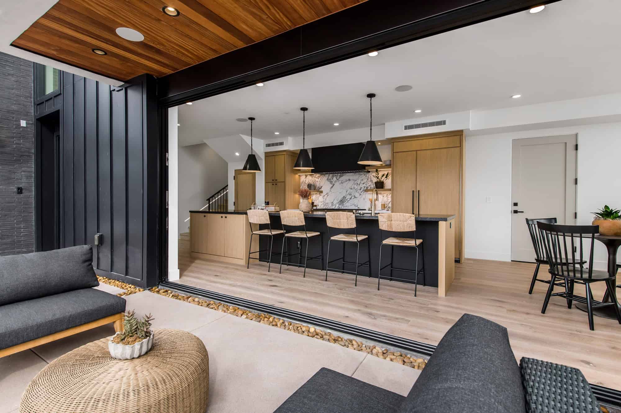 A modern kitchen and dining area with a bar.