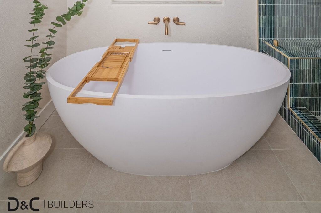 Bathtub in green-tiled bathroom