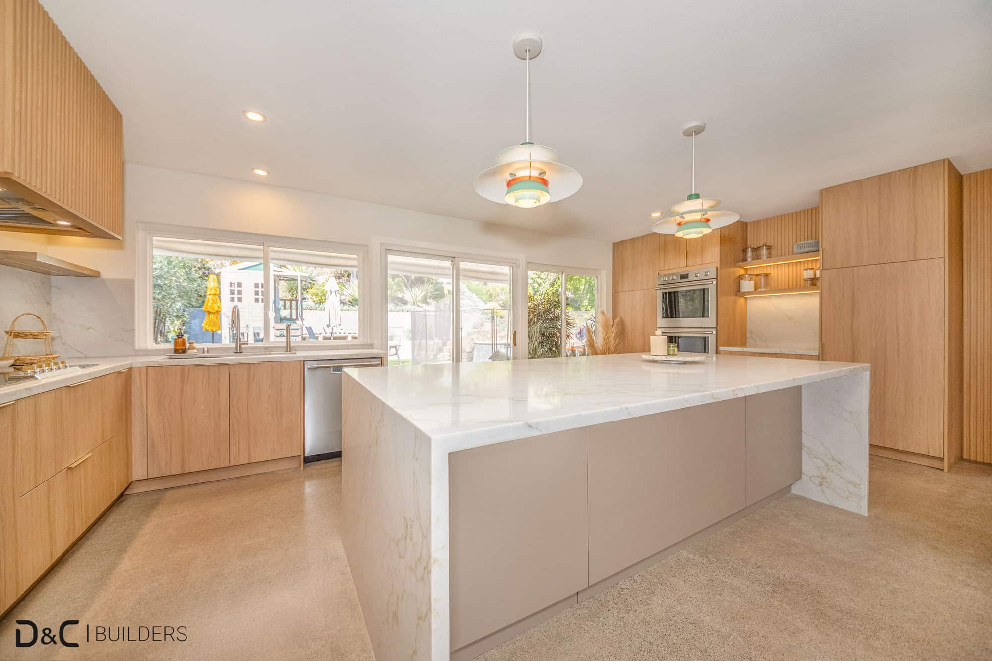A kitchen with a large island and wooden cabinets.