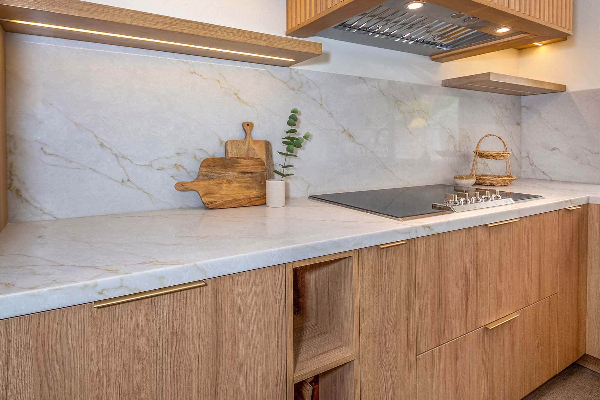 A kitchen with wooden cabinets and marbel counter top in mission vieho