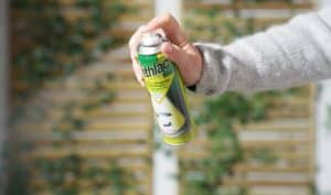 Person holding Dethlac spray can for Coshh safety compliance.