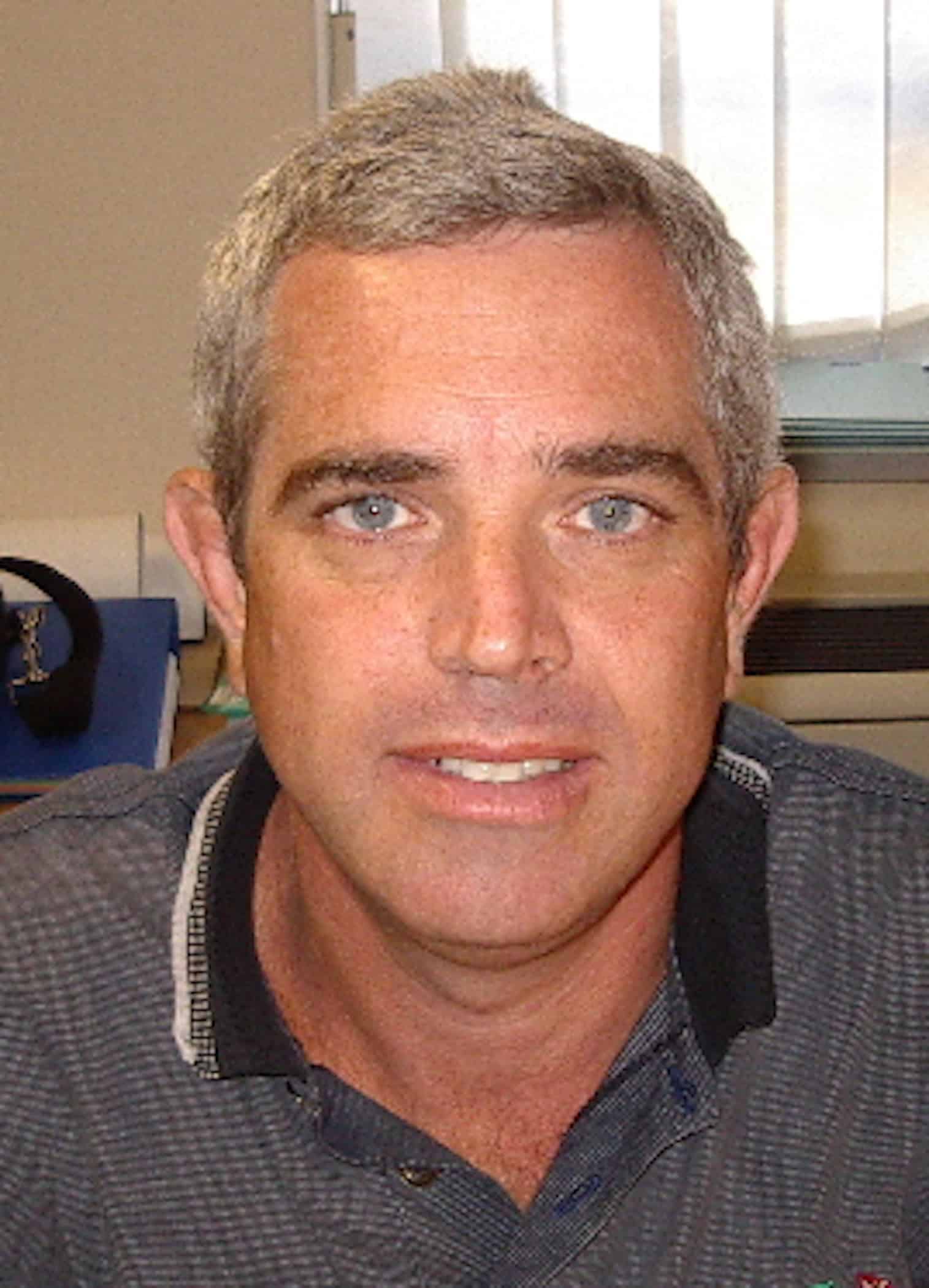 Healthcare professional Malcolm Collins in a professional setting.
