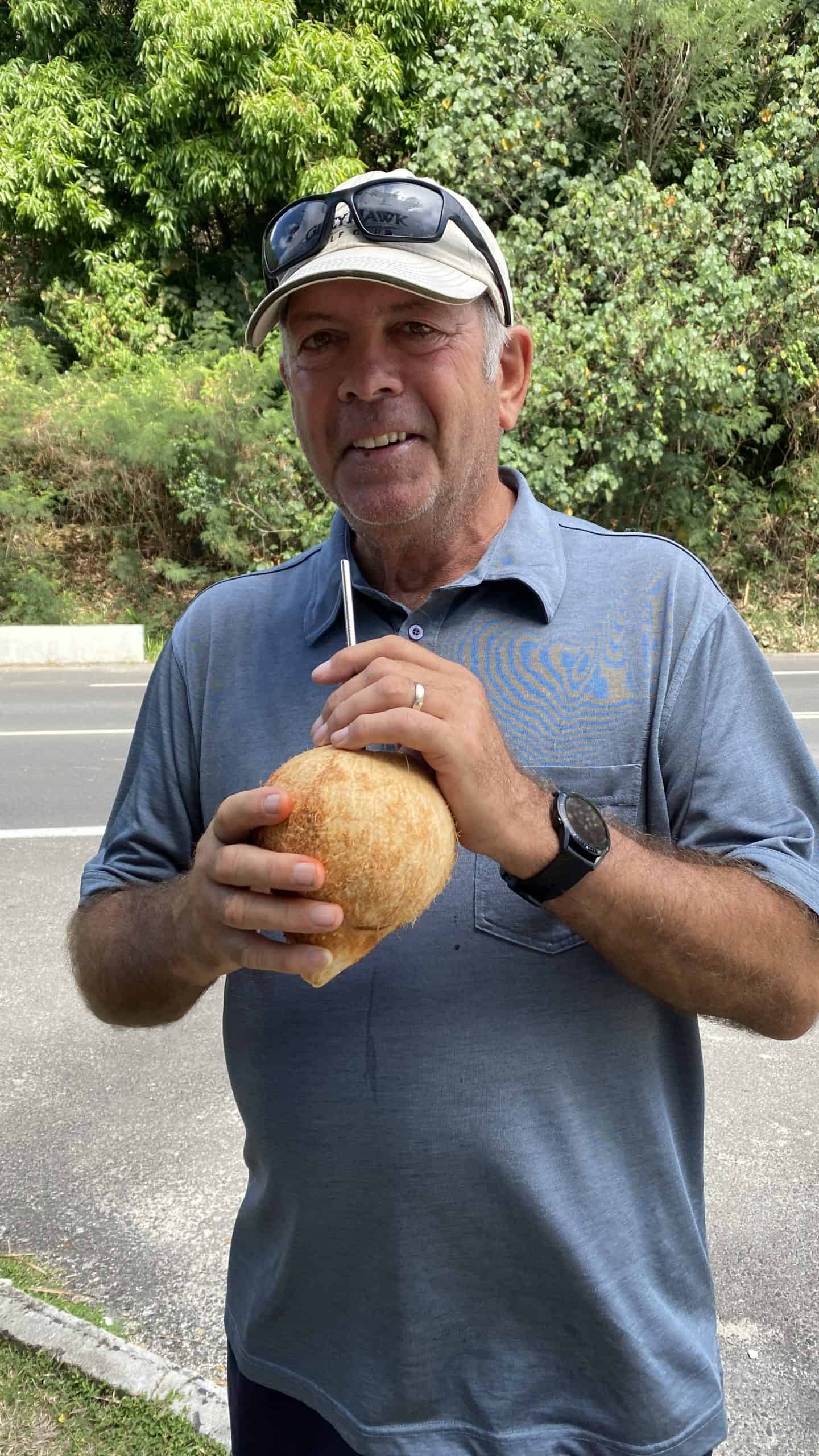 Denis drinking fresh coconut water