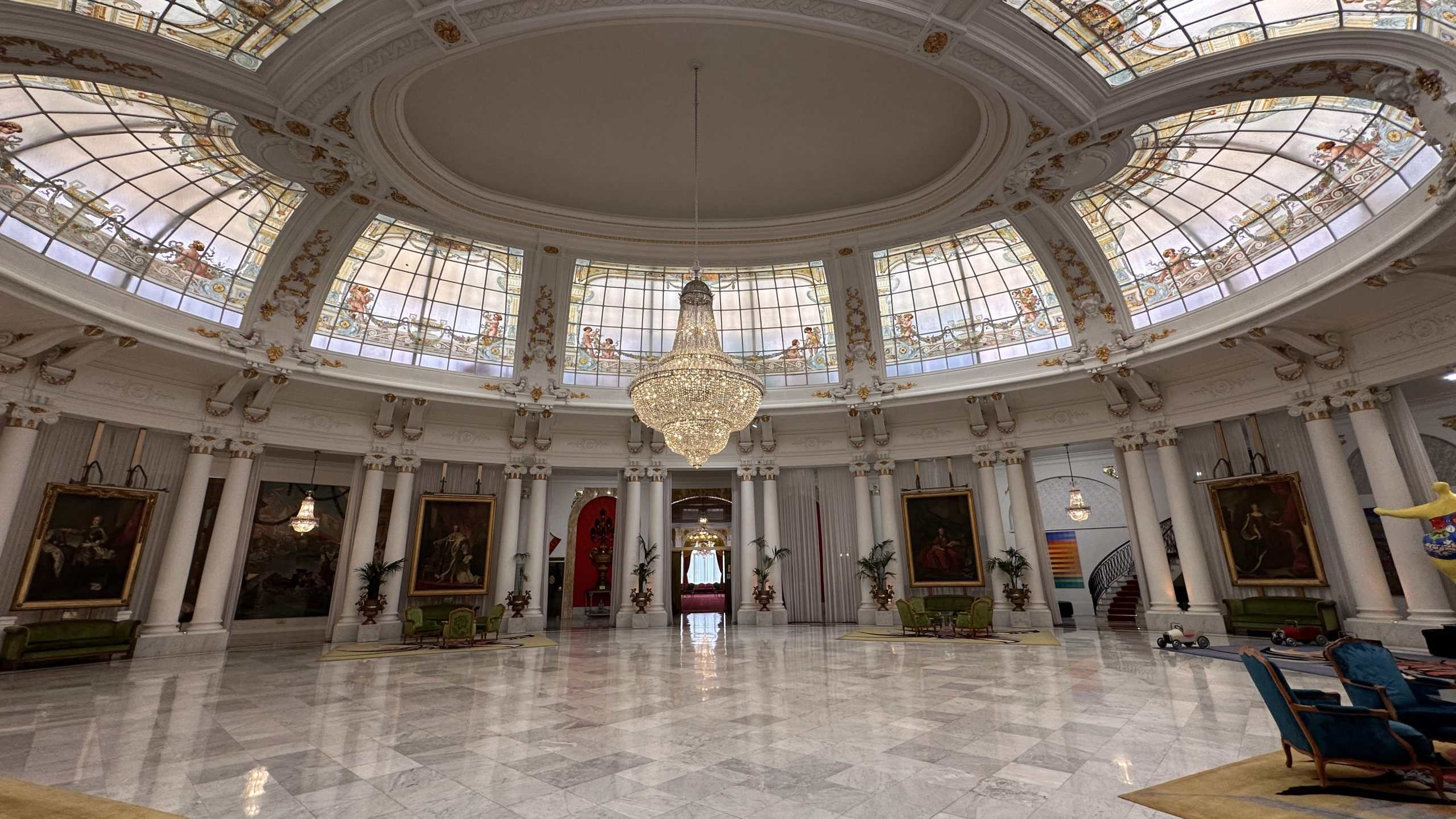 Chandelier hanging in room with domed ceiling
