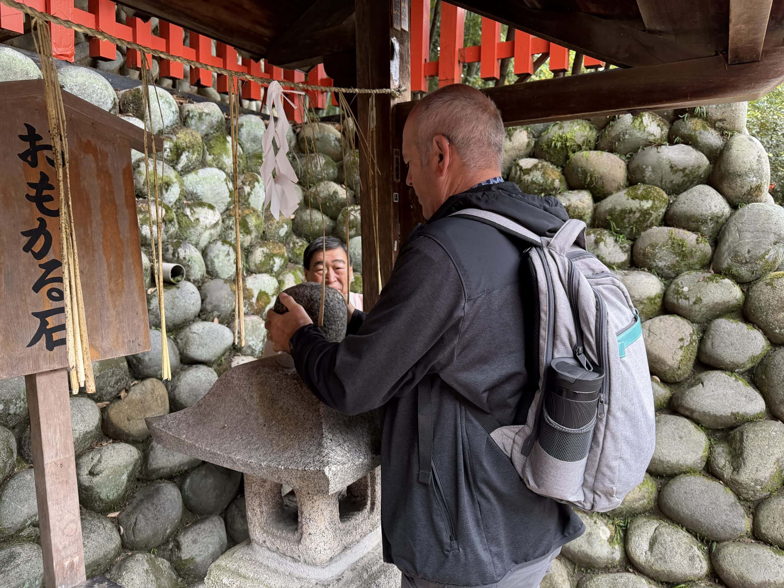Denis trying to lift the stone ball