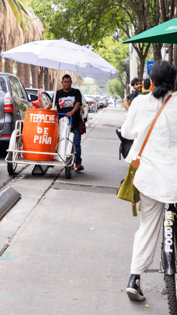 Travelers riding bikes through Roma Norte during Mexico City food tour