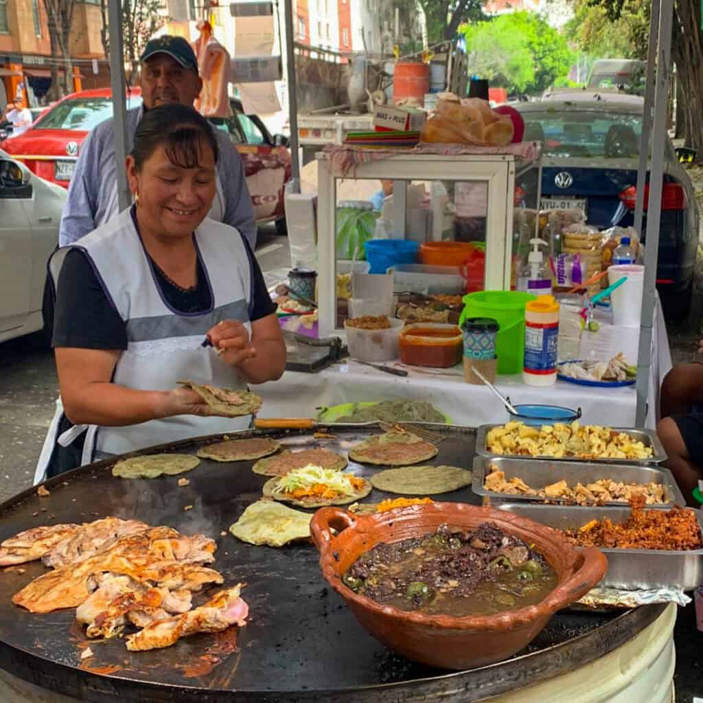Guests eating tacos at a family-run street food stand in CDMX.