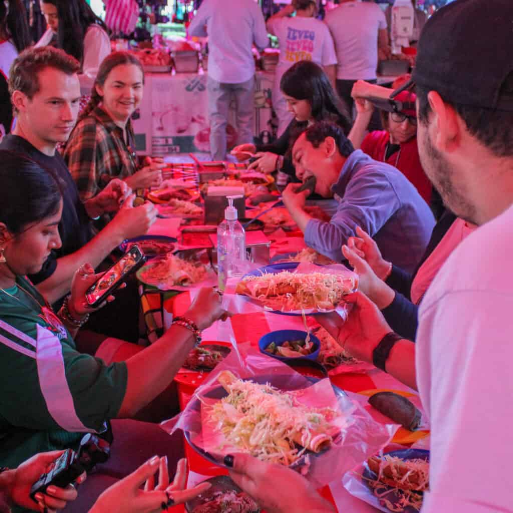 Travelers exploring CDMX on bikes during a Food Hood street food tour