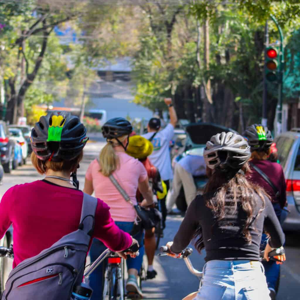 Travelers exploring Mexico City on bikes during a Food Hood street food tour.