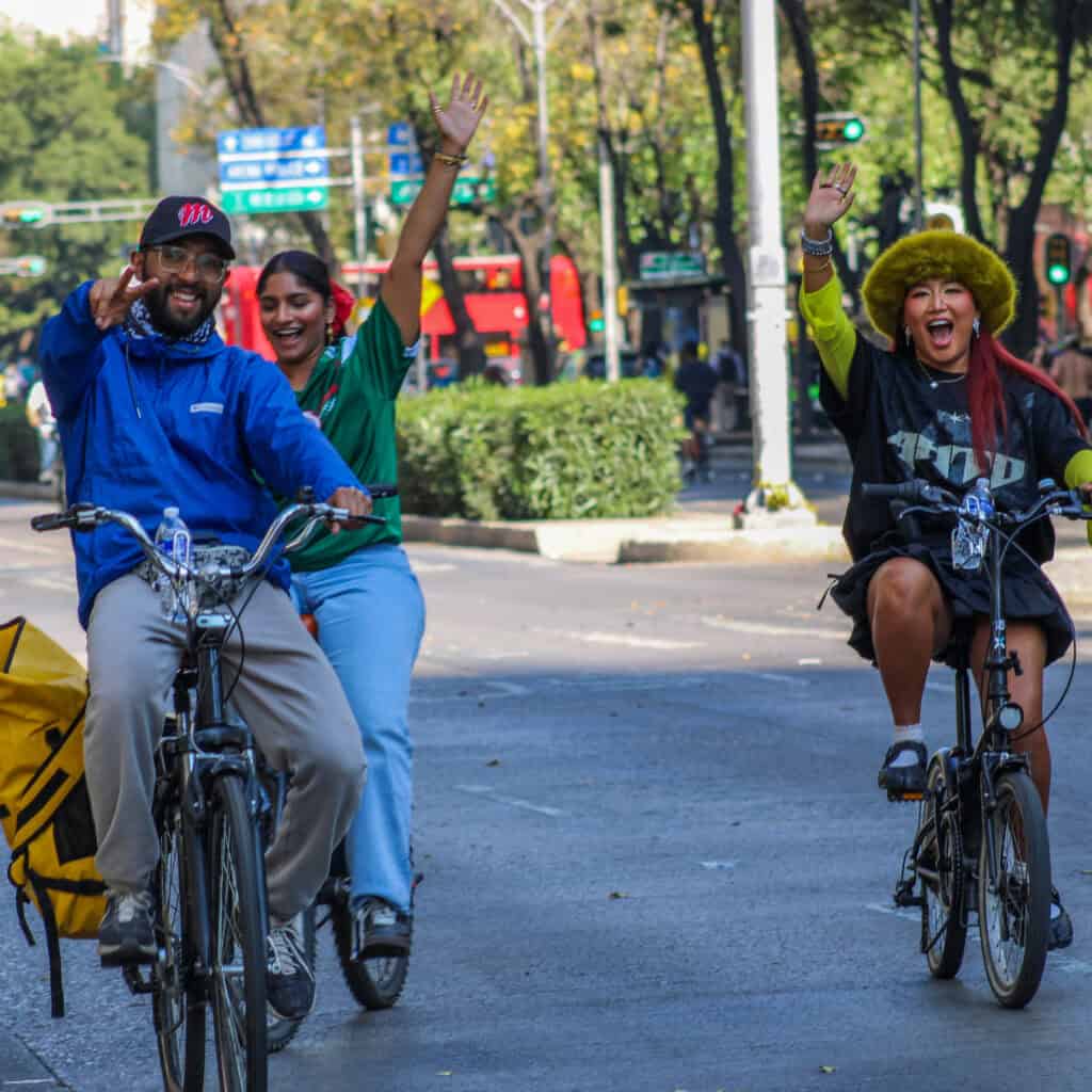 : Guests riding bicycles through a peaceful CDMX neighborhood on a Food Hood tour.