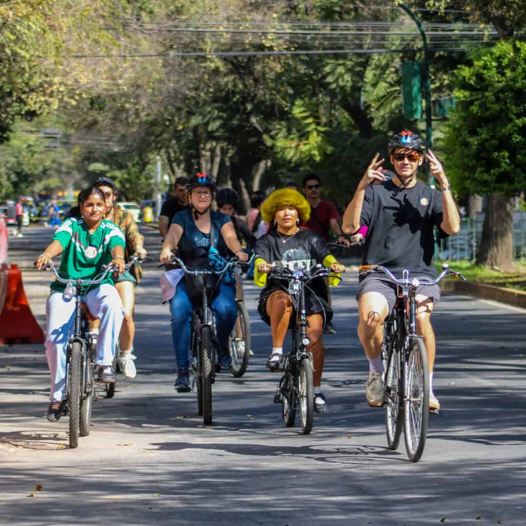 Guests riding through colorful streets during the Food Hood Mexico tour.
